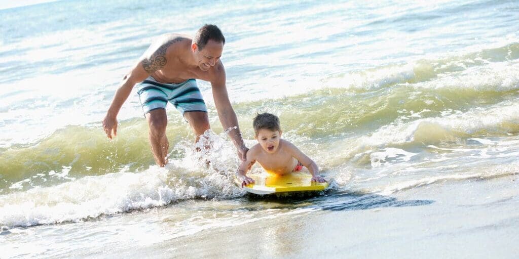 FATHER-SON-ON-BOOGIE-BOARD0210_cc-2100x1400-e5eacfc0-c1b4-42e1-922a-14f9de1b329c