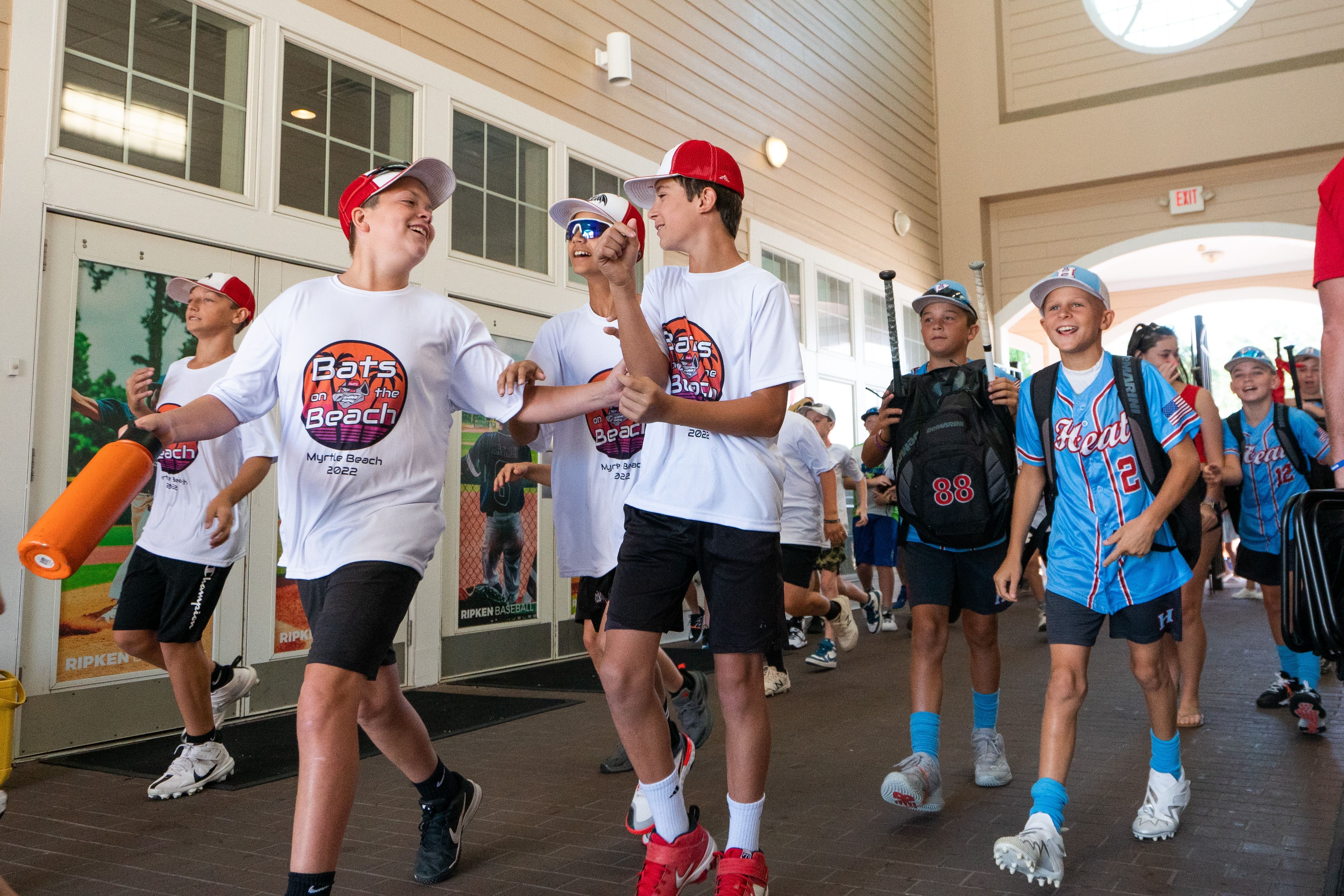 baseball players walking into The Ripken Experience® Myrtle Beach for a tournament